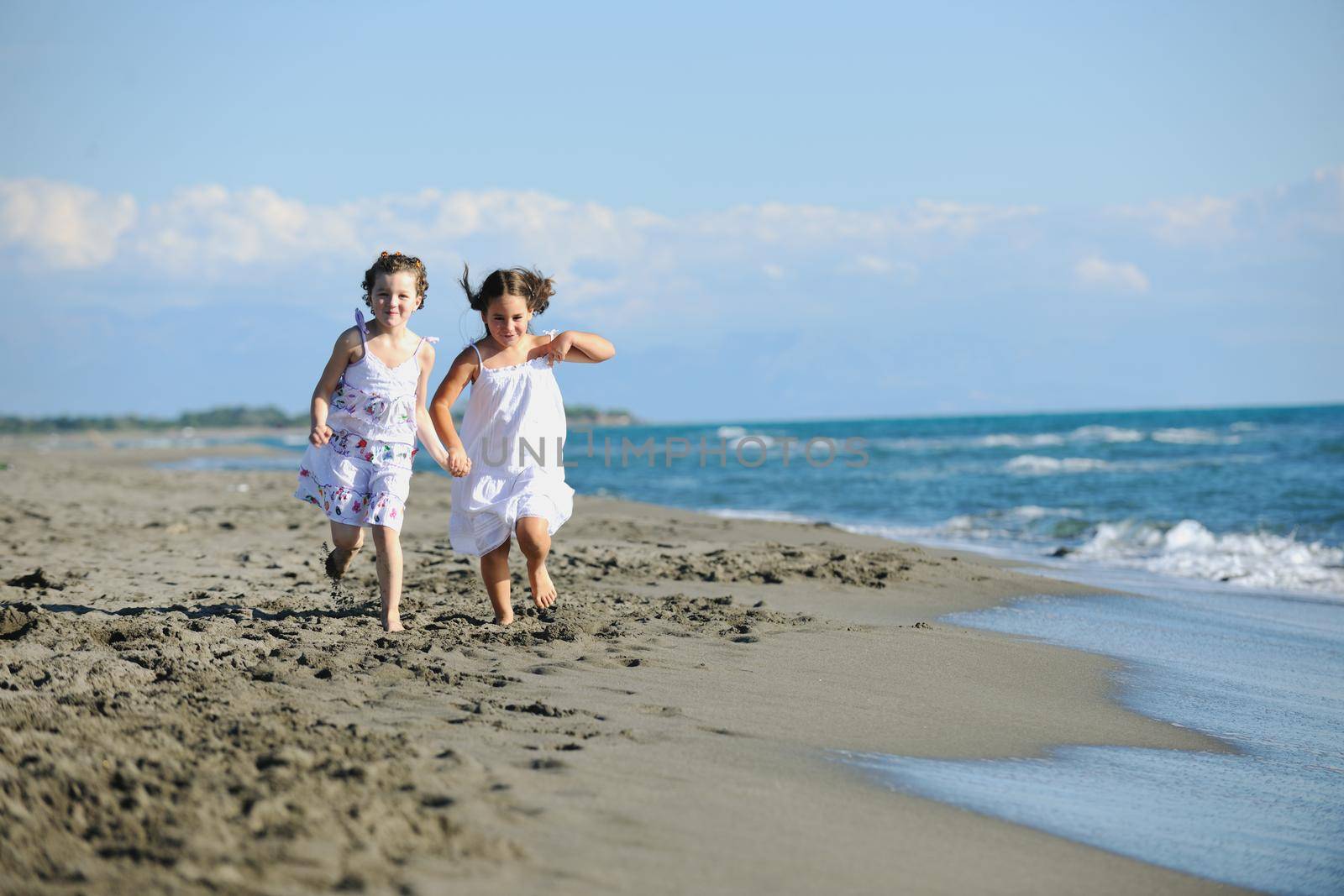 cute little girls running on beach by dotshock