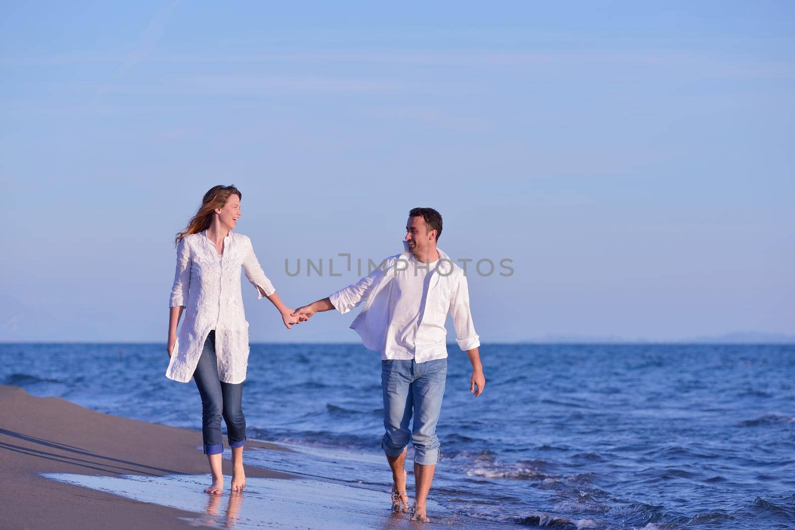 young couple  on beach have fun by dotshock