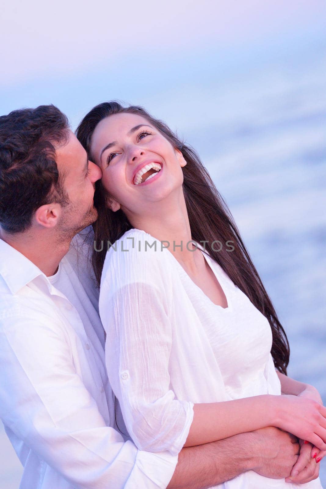 young couple  on beach have fun by dotshock