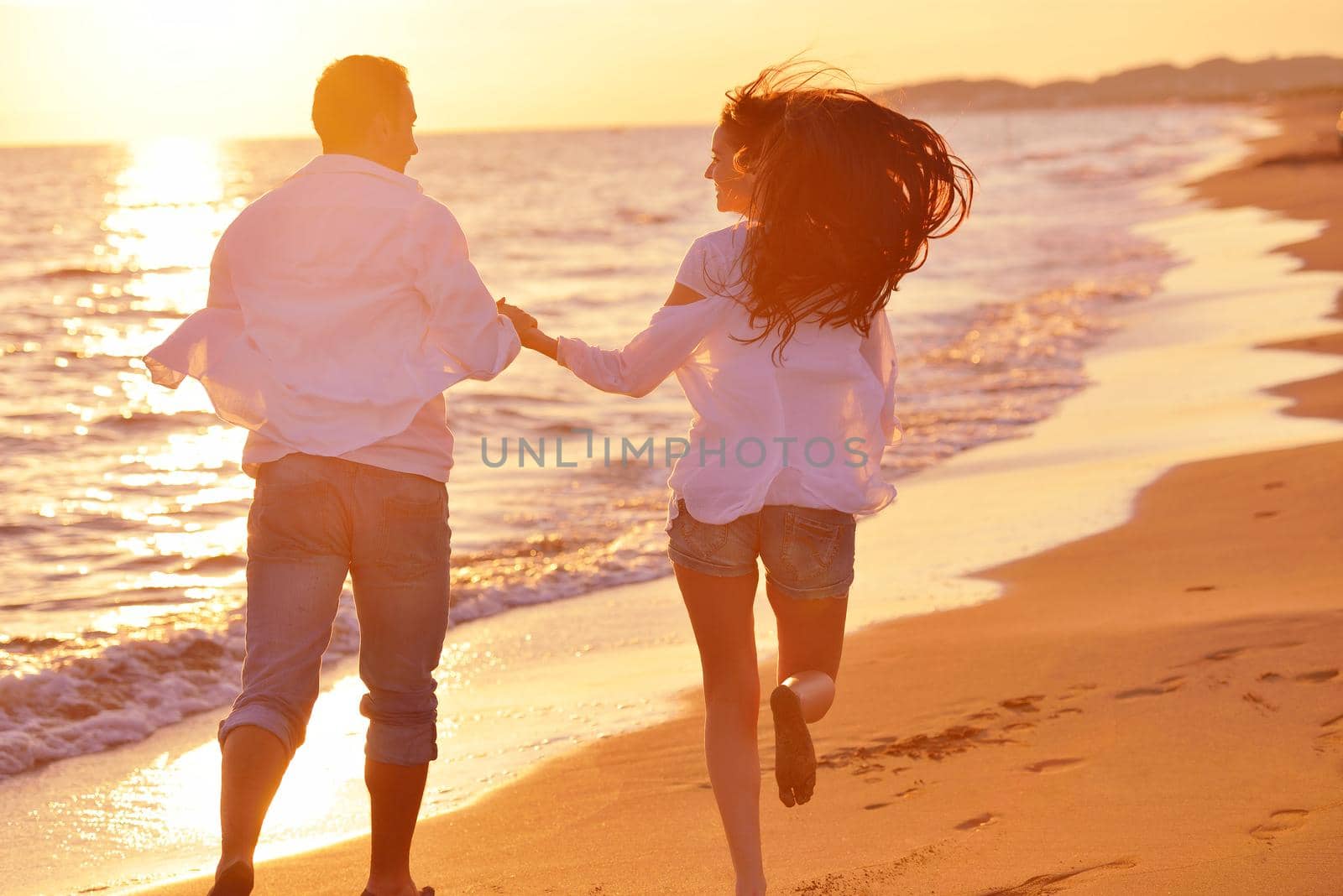 happy young romantic couple in love have fun on beautiful beach at beautiful summer day