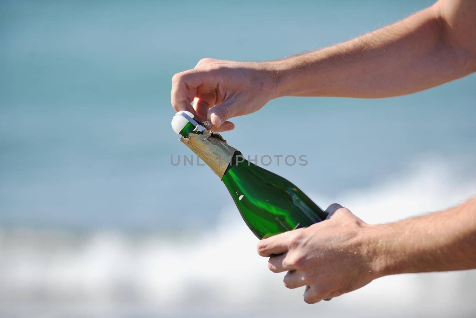 man hands open bottle of champagne alcohol and wine drink outdoor on party celebration event 