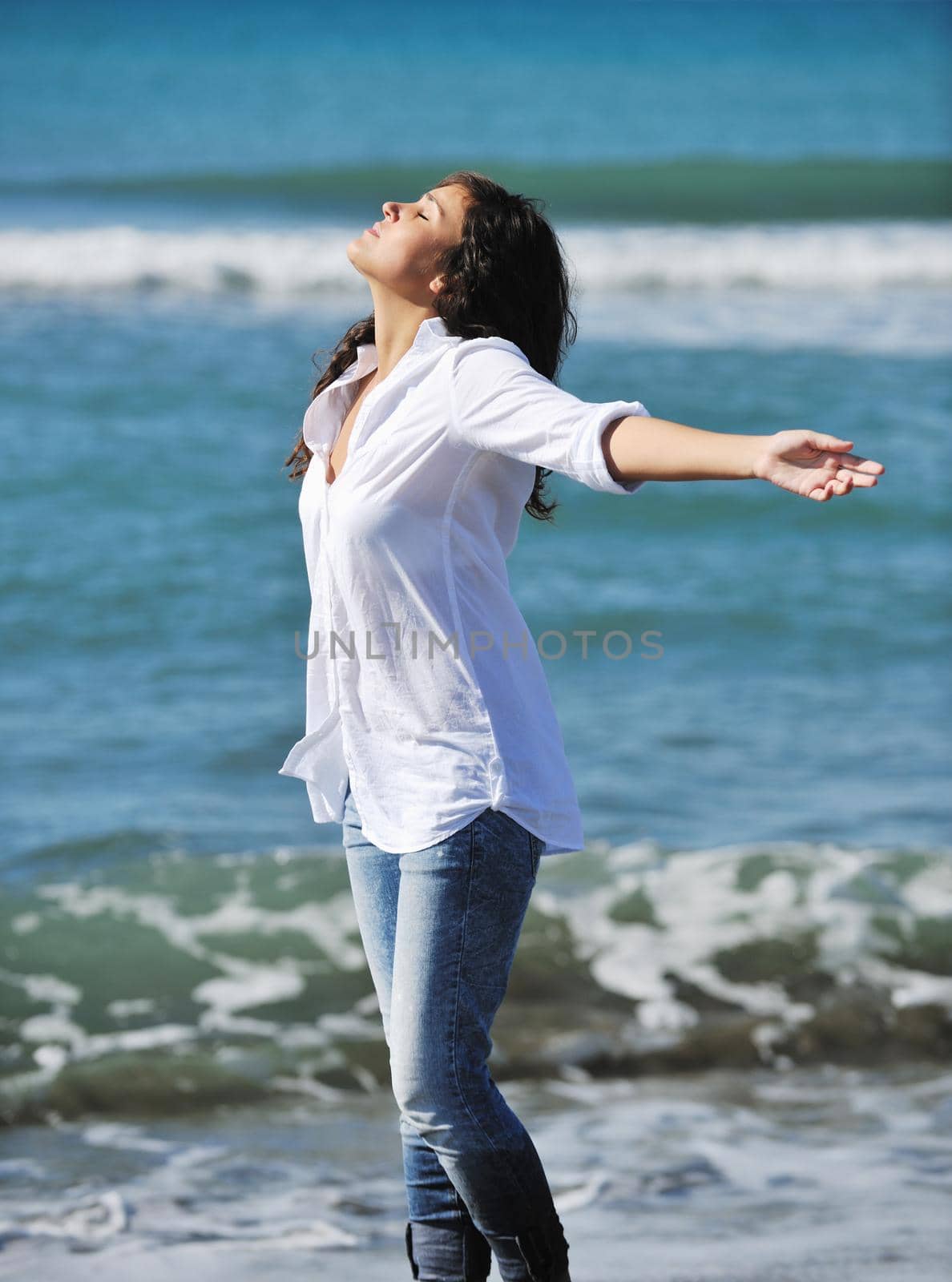 happy young woman on beach by dotshock