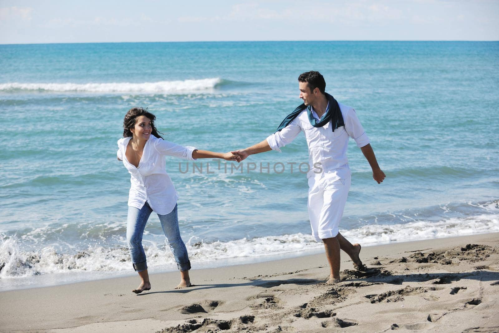 happy young couple in white clothing  have romantic recreation and   fun at beautiful beach on  vacations