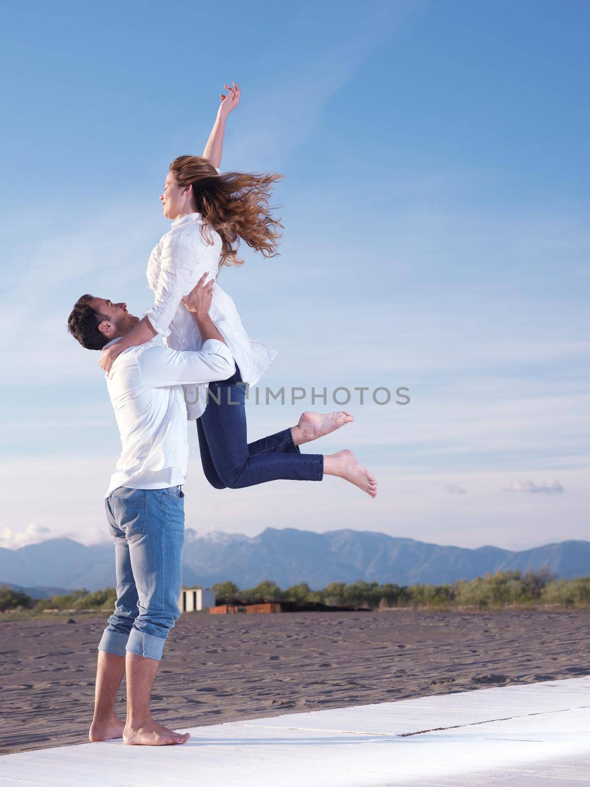 young couple  on beach have fun by dotshock