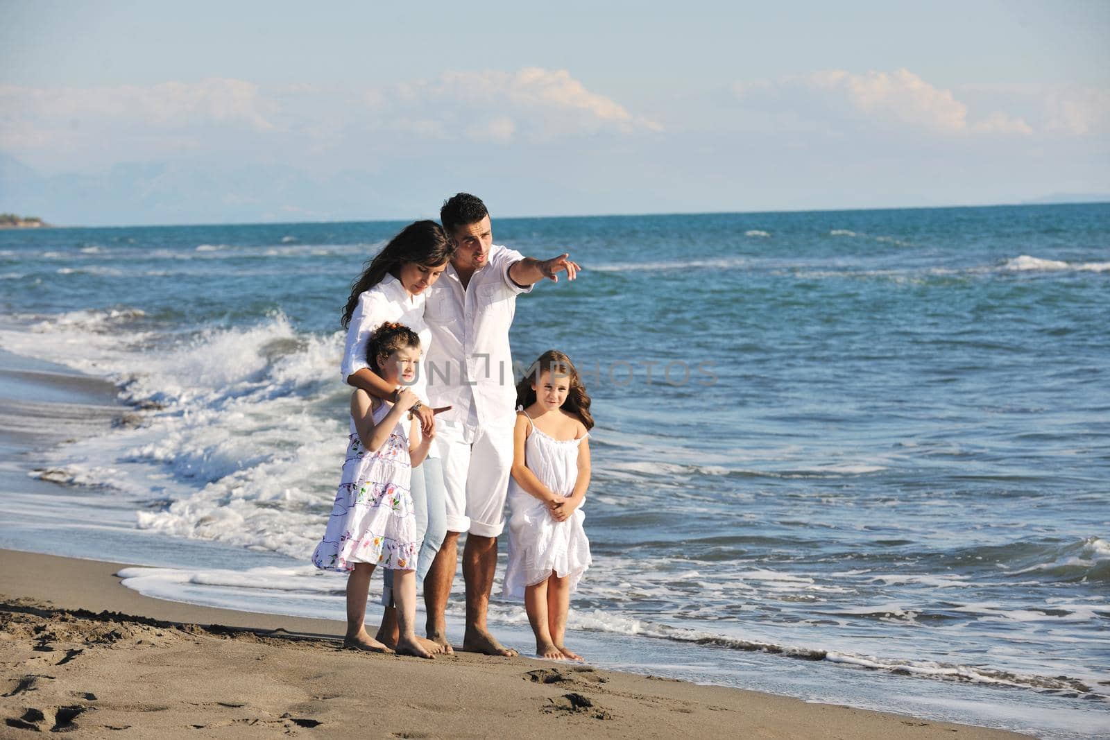 happy young  family have fun on beach by dotshock