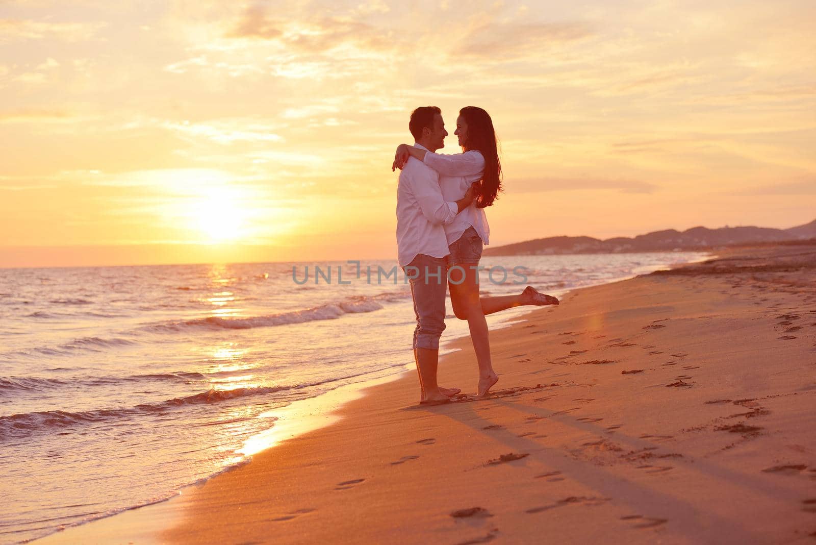 happy young romantic couple in love have fun on beautiful beach at beautiful summer day