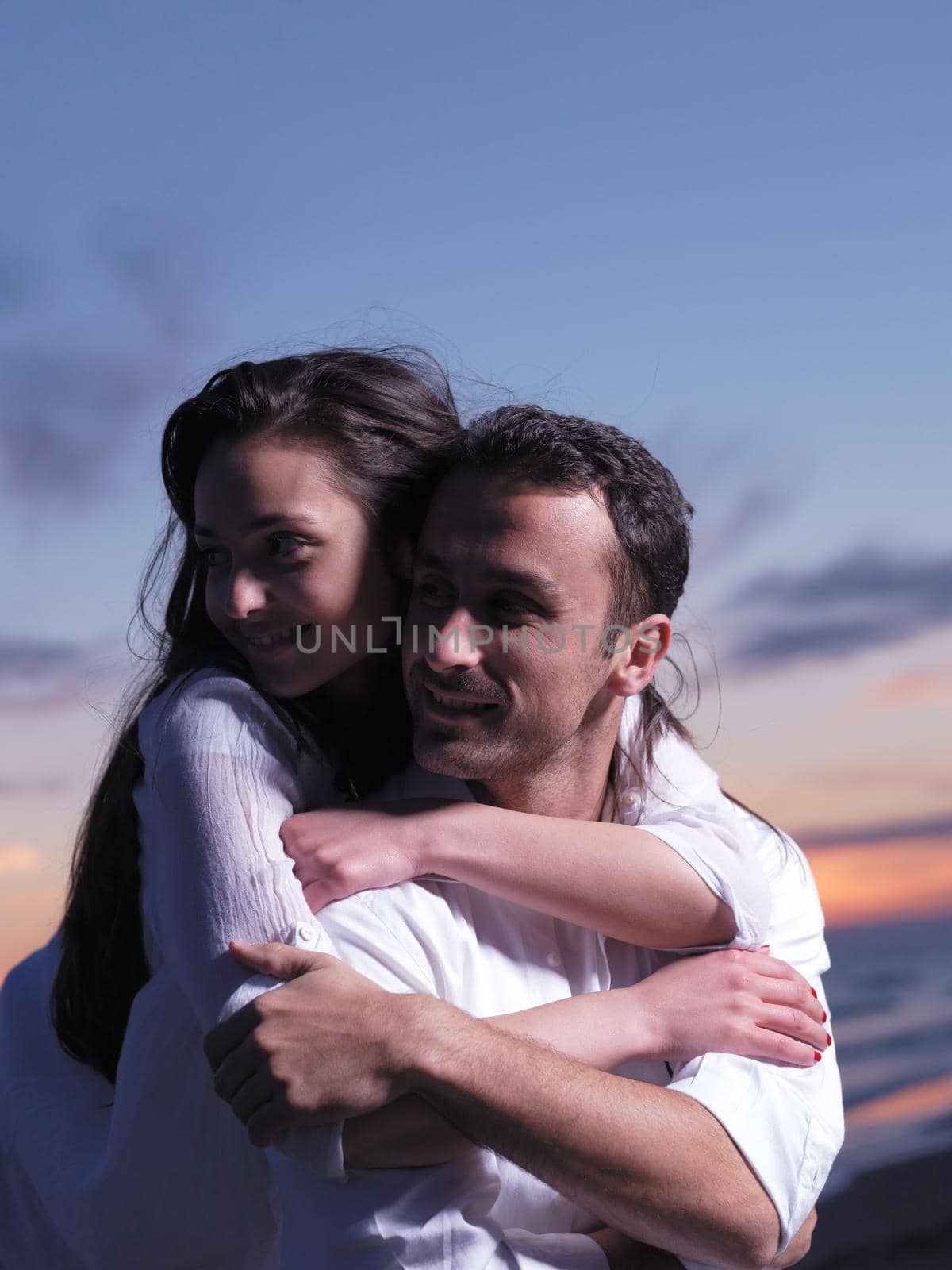 happy young romantic couple in love have fun on beautiful beach at beautiful summer day