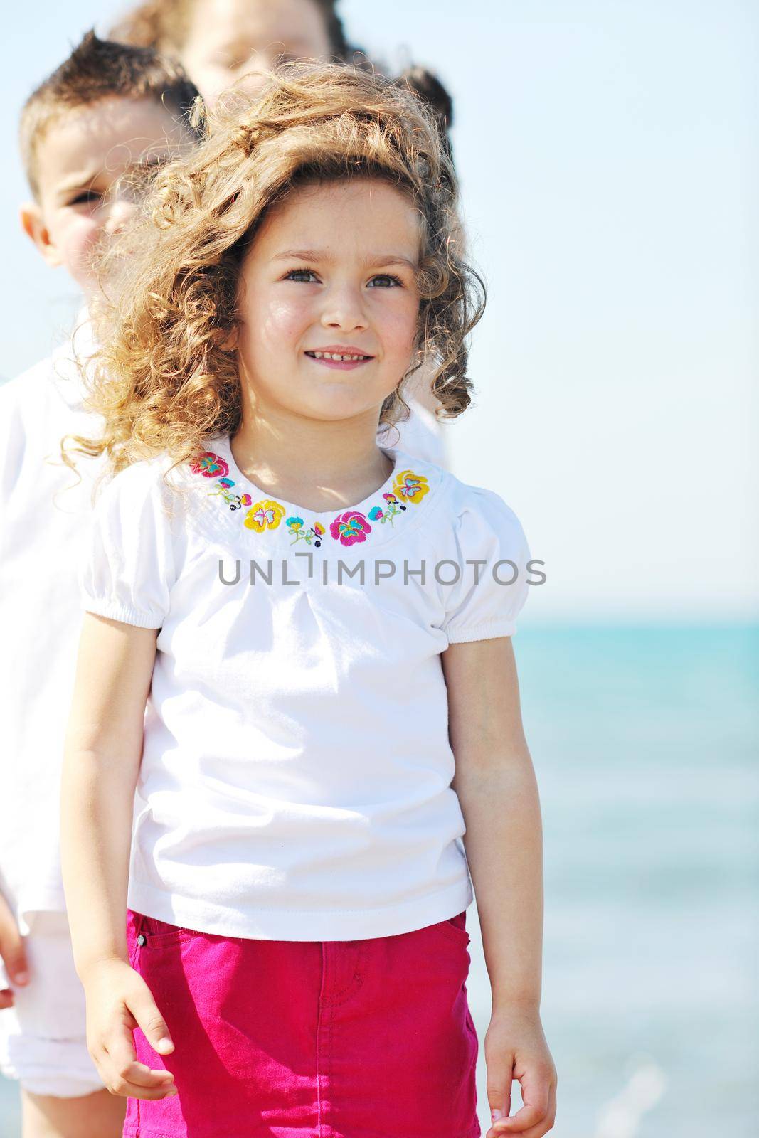 group of happy child on beach who have fun and play games