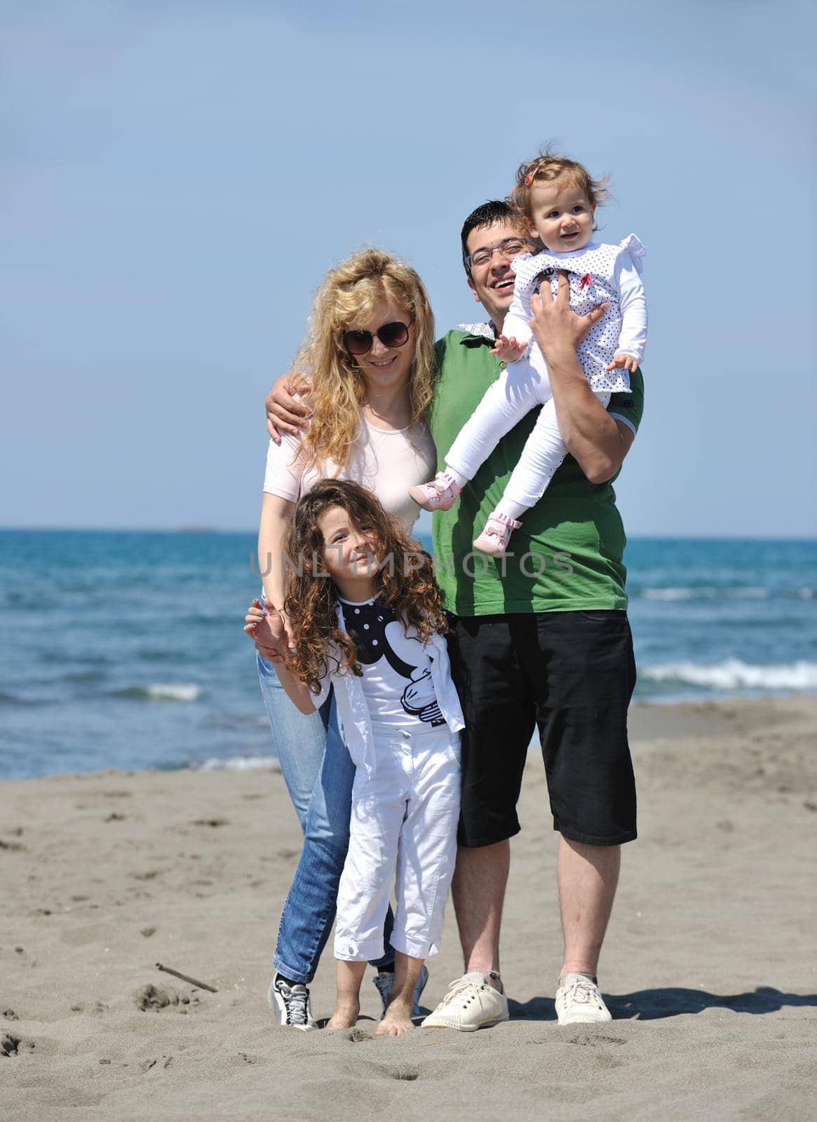 happy young family have fun and live healthy lifestyle on beach