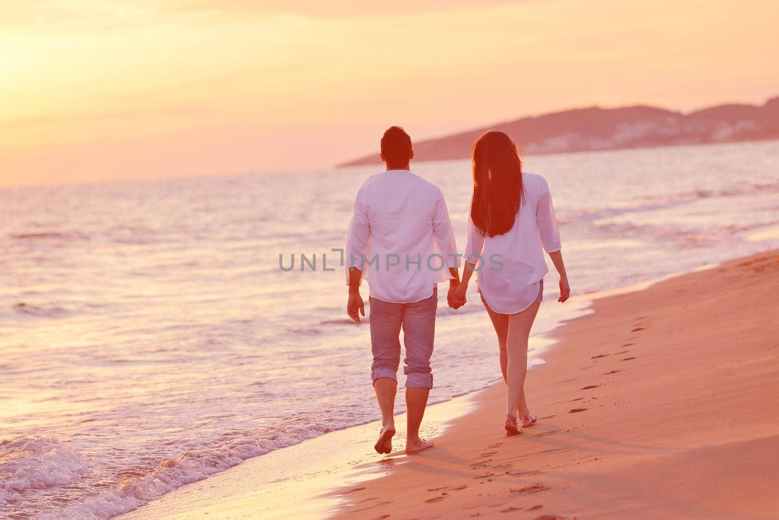 young couple  on beach have fun by dotshock