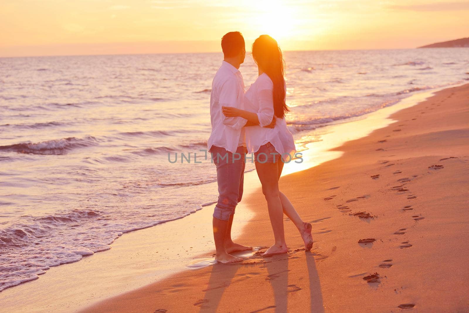 happy young romantic couple in love have fun on beautiful beach at beautiful summer day