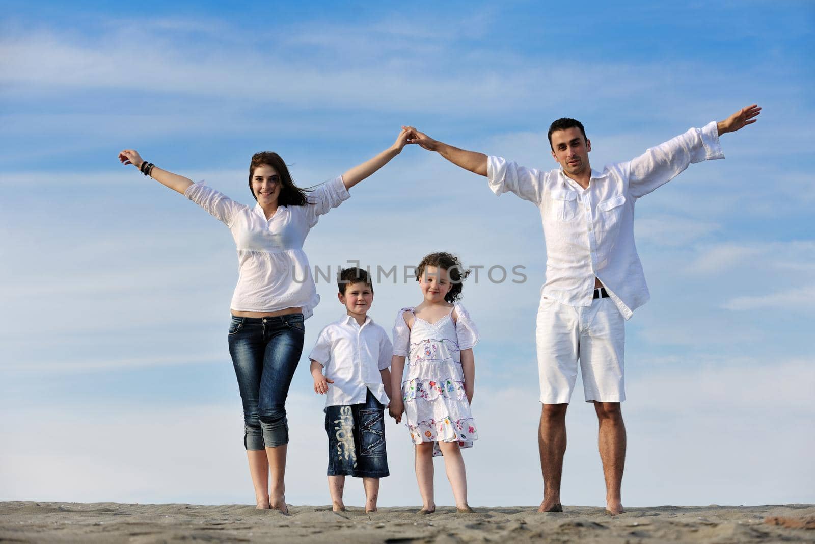 family on beach showing home sign by dotshock