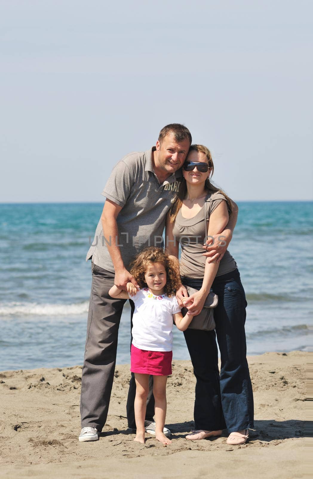 happy young family have fun and live healthy lifestyle on beach