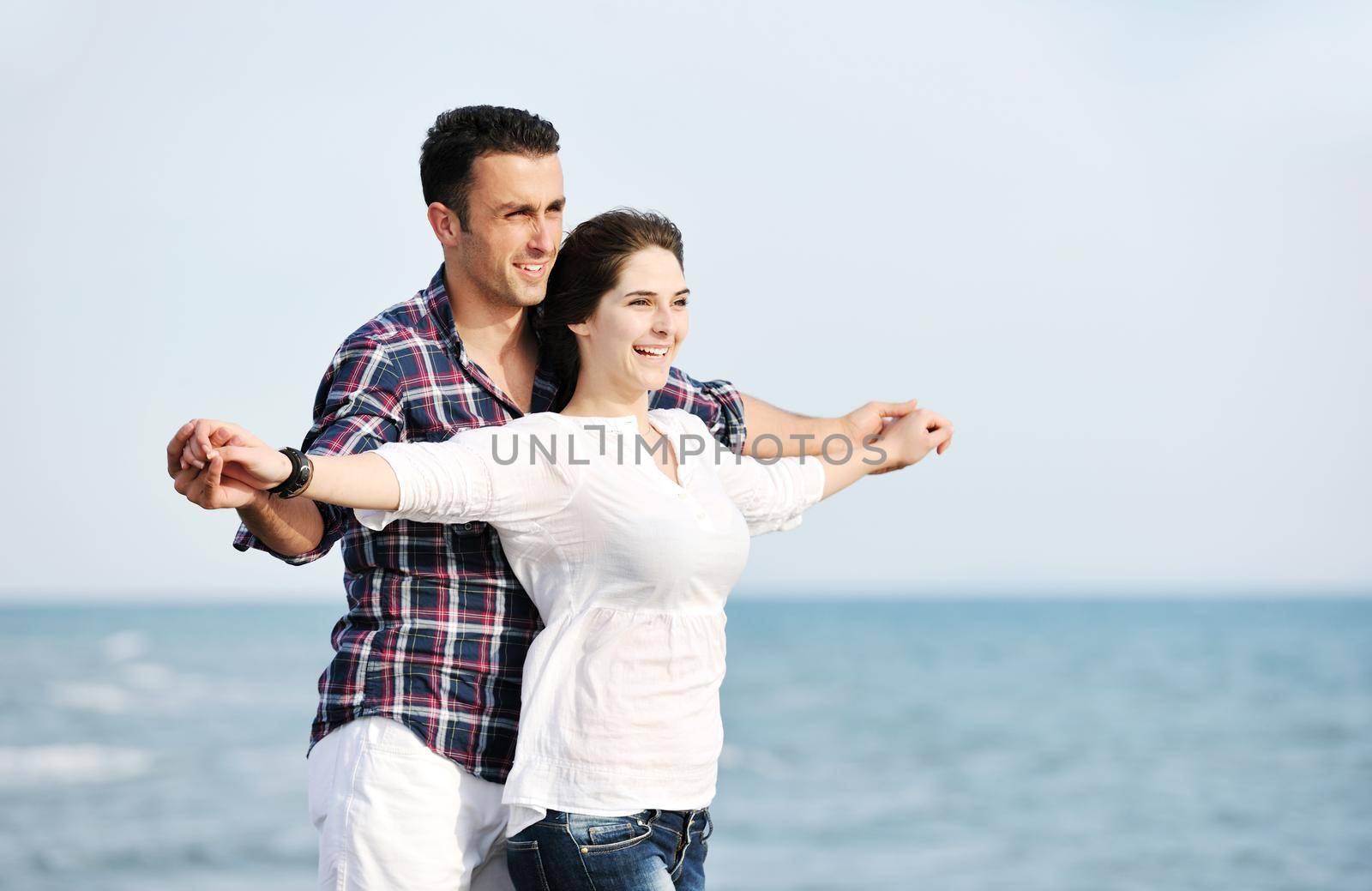 happy young couple have fun and romantic moments on beach at summer season and representing happynes and travel concept