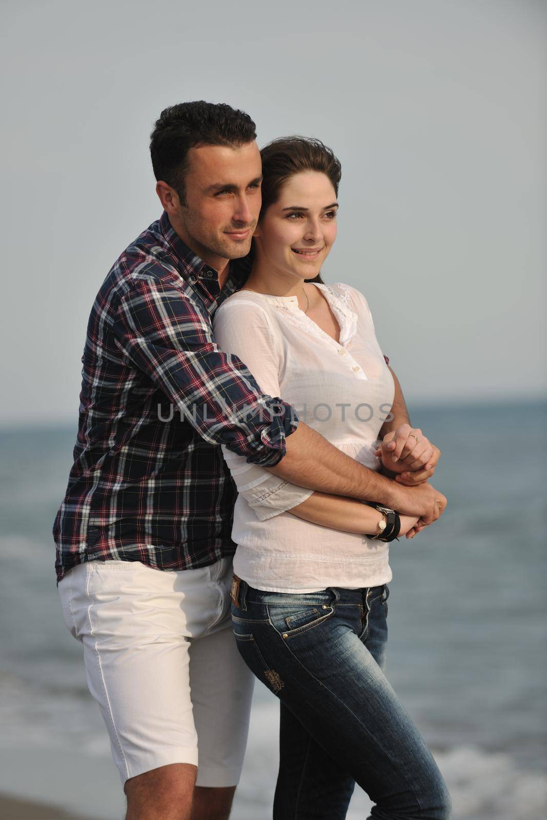 happy young couple have fun on beach by dotshock