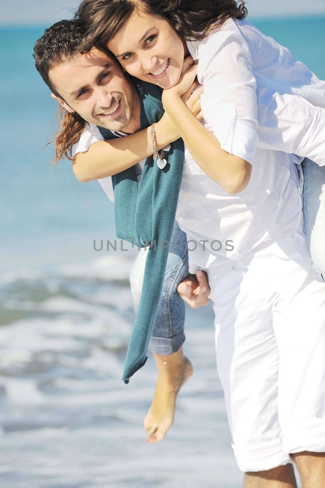 happy young couple have fun at beautiful beach by dotshock