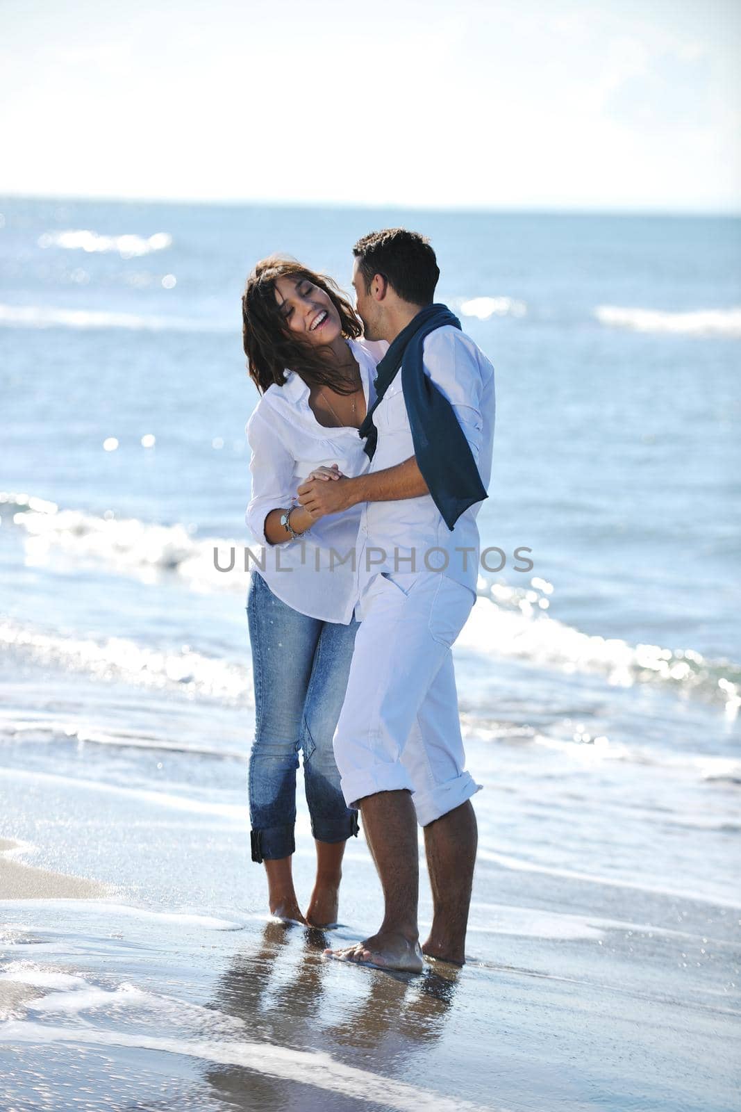 happy young couple have fun at beautiful beach by dotshock