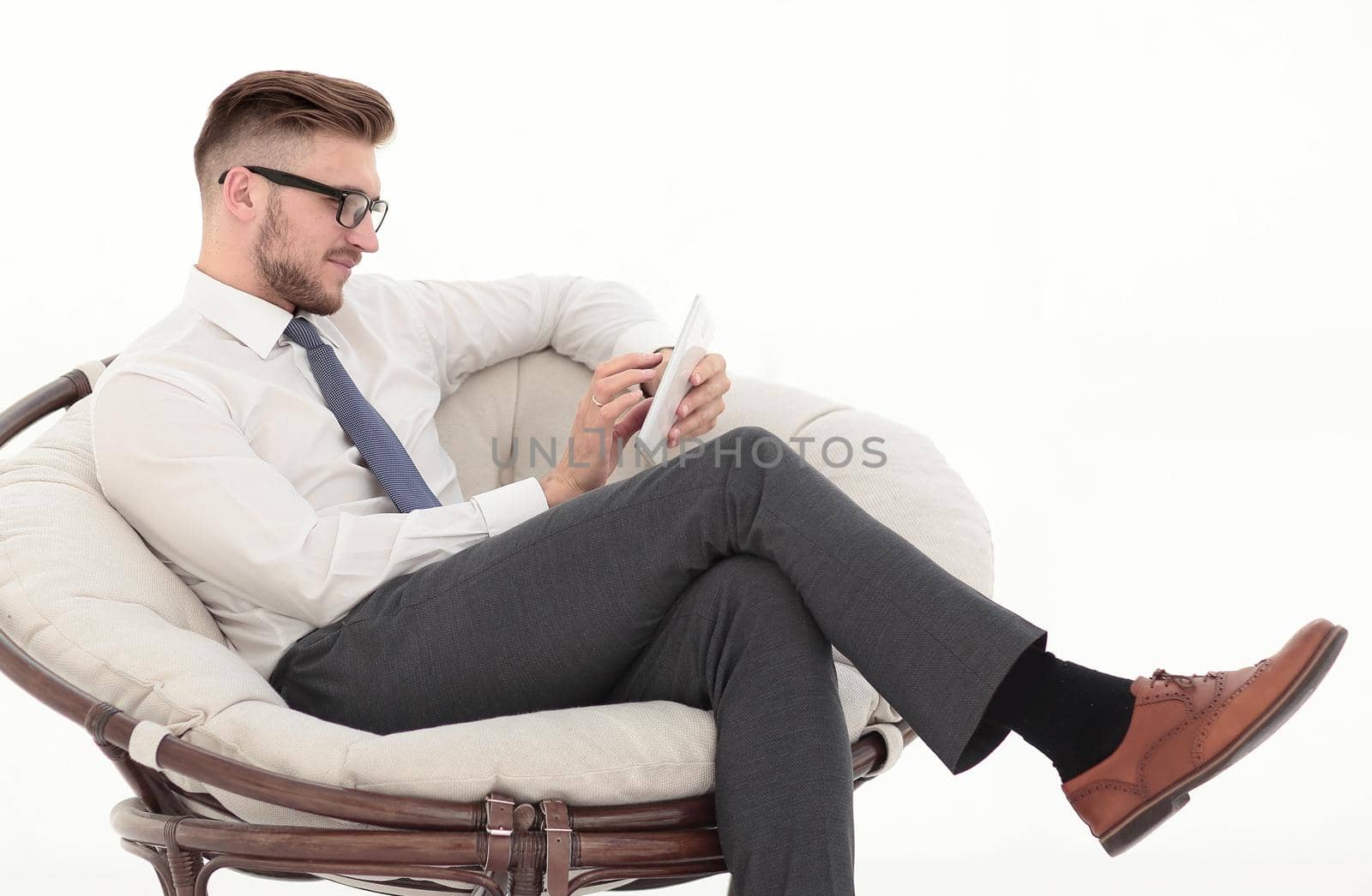 businessman with digital tablet sitting in the chair. isolated by asdf