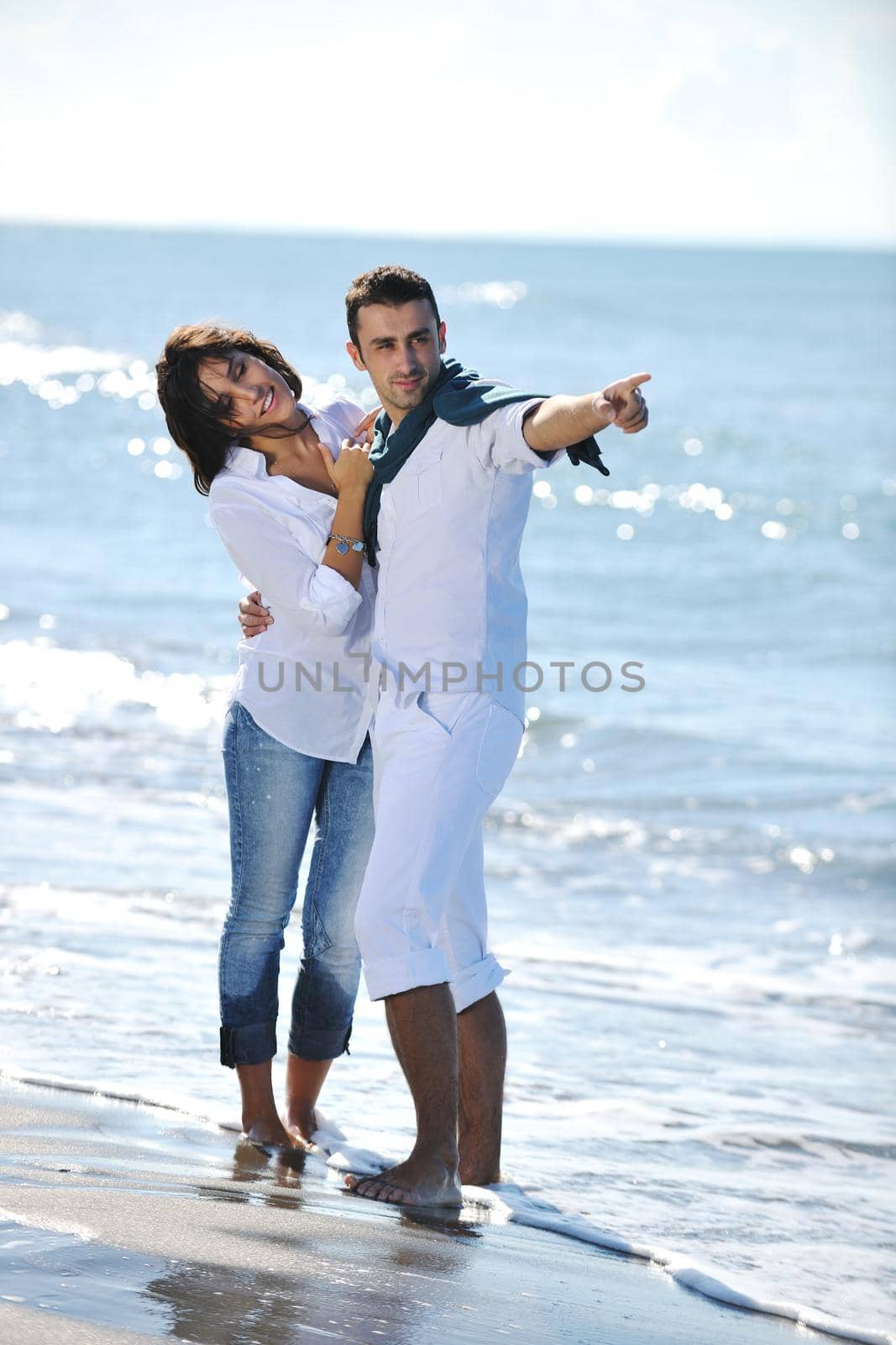 happy young couple have fun at beautiful beach by dotshock