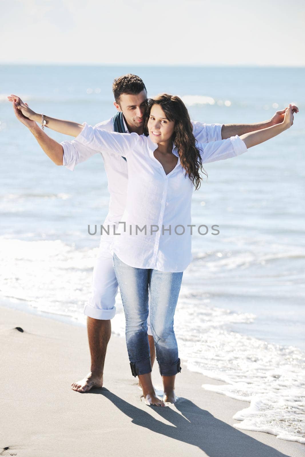 happy young couple in white clothing  have romantic recreation and   fun at beautiful beach on  vacations