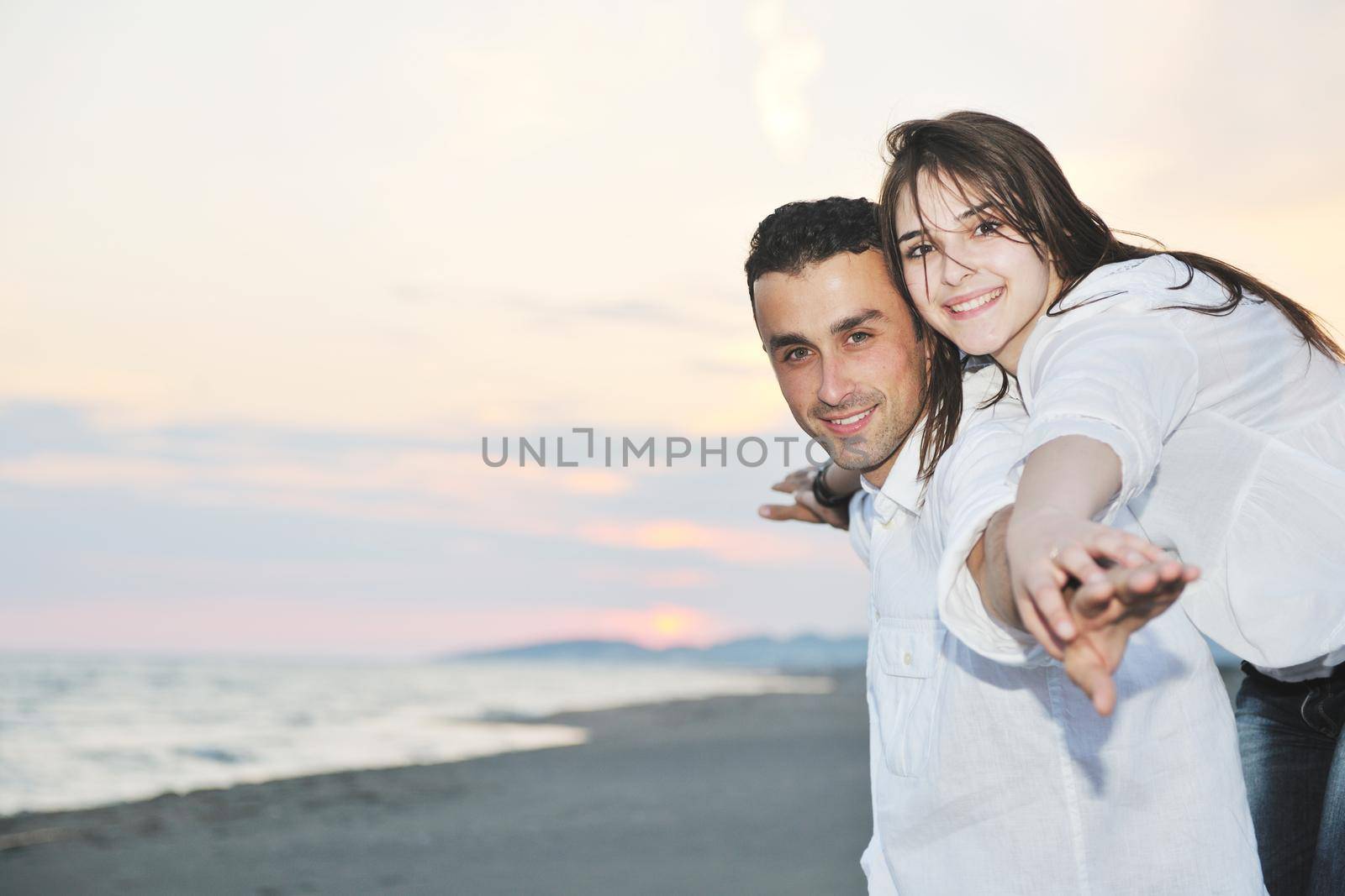 happy young couple have fun and romantic moments on beach at summer season and representing happynes and travel concept