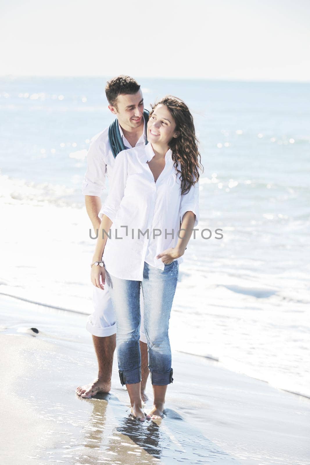 happy young couple in white clothing  have romantic recreation and   fun at beautiful beach on  vacations