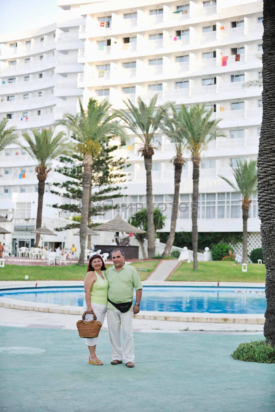 happy senior mature elderly people couple have romantic time on beach at sunset 