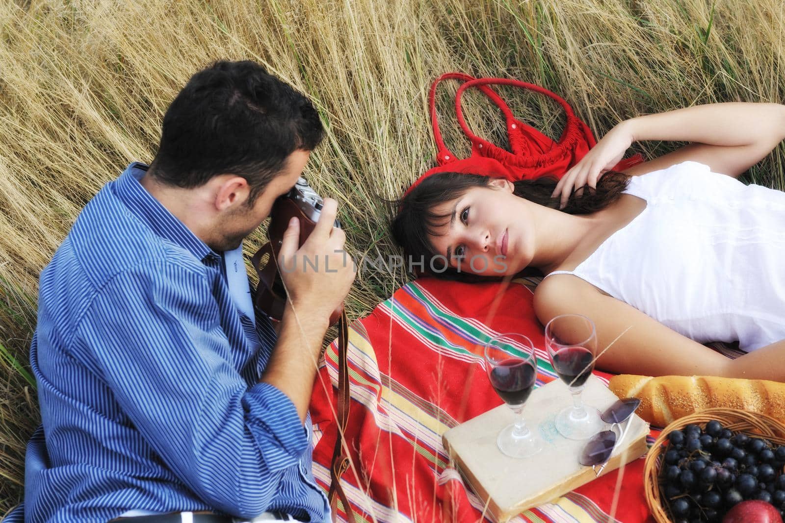 happy young couple relaxing in nature white making photos and taking images and posing for camera