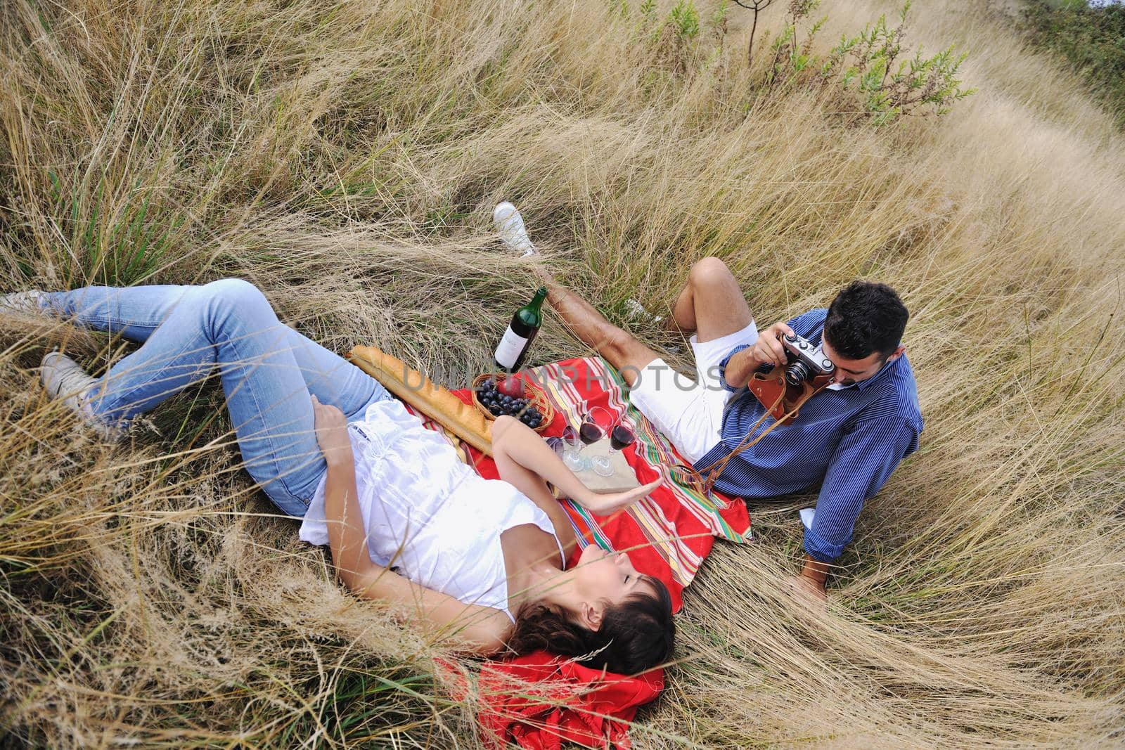 happy young couple relaxing in nature white making photos and taking images and posing for camera