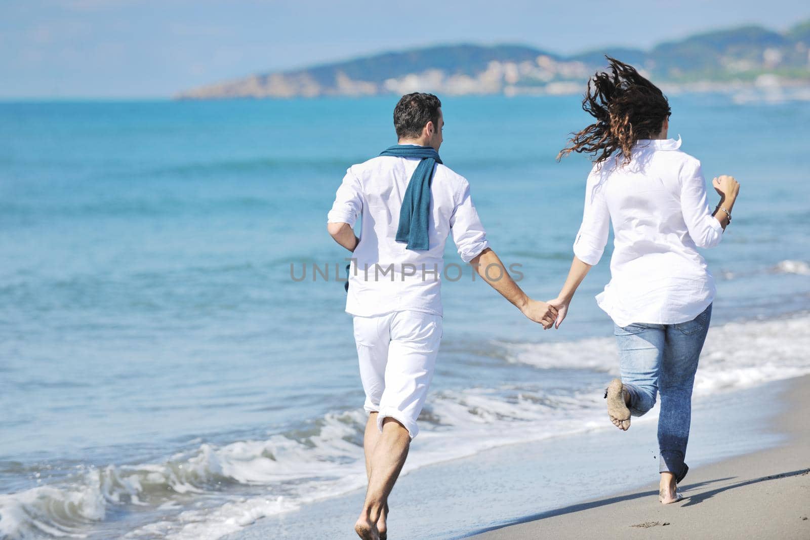 happy young couple in white clothing  have romantic recreation and   fun at beautiful beach on  vacations