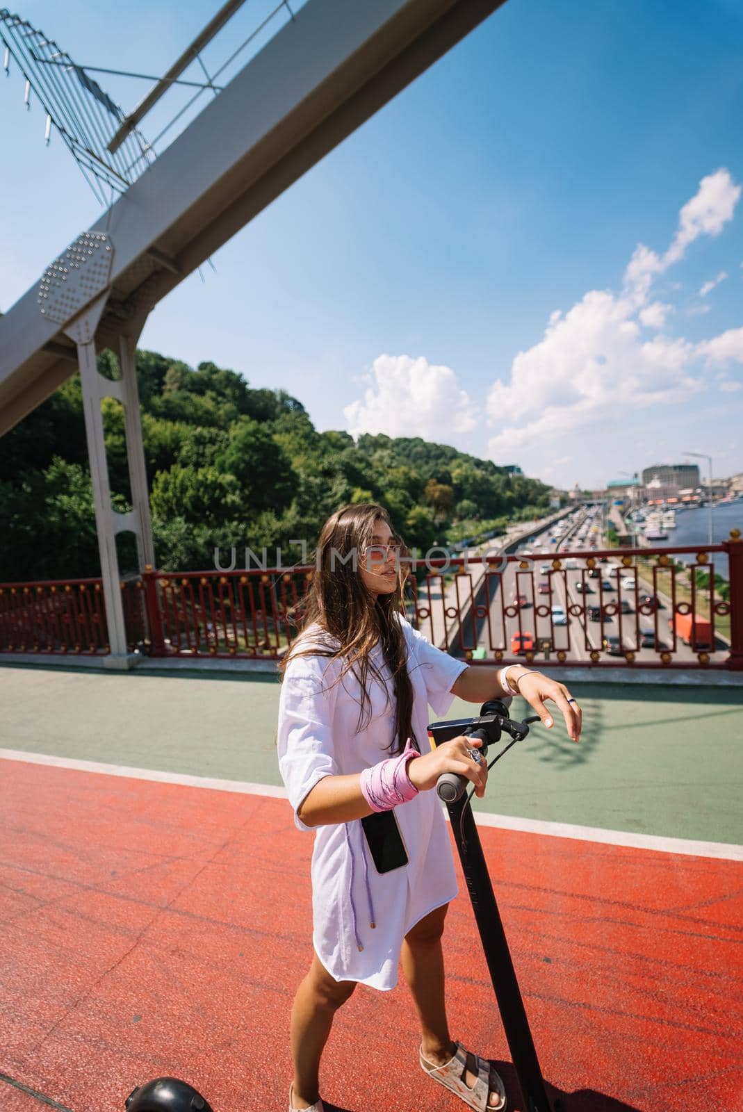 Young beautiful woman and an electric scooter, modern girl, new generation, electric transport, ecological transport