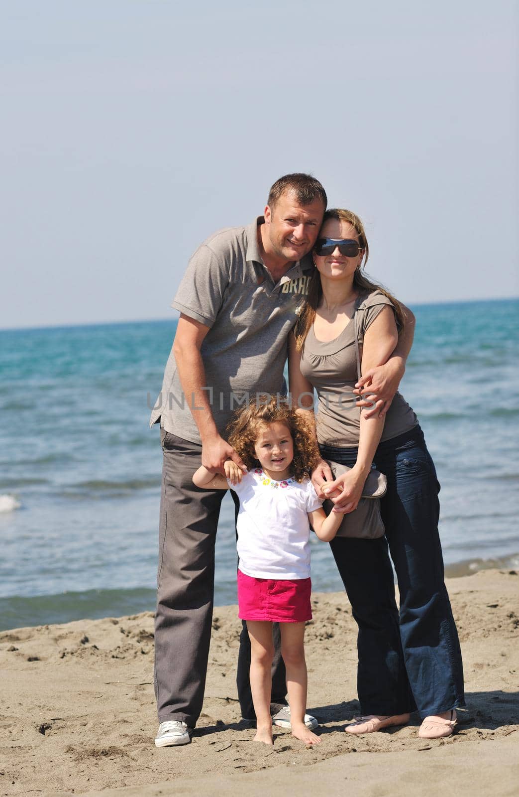 happy young family have fun and live healthy lifestyle on beach