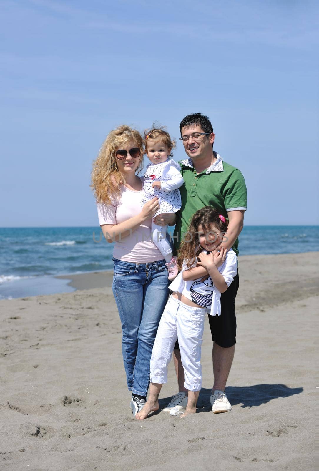 happy young family have fun and live healthy lifestyle on beach