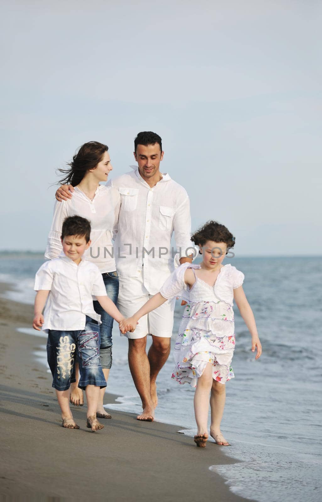 happy young family have fun and live healthy lifestyle on beach