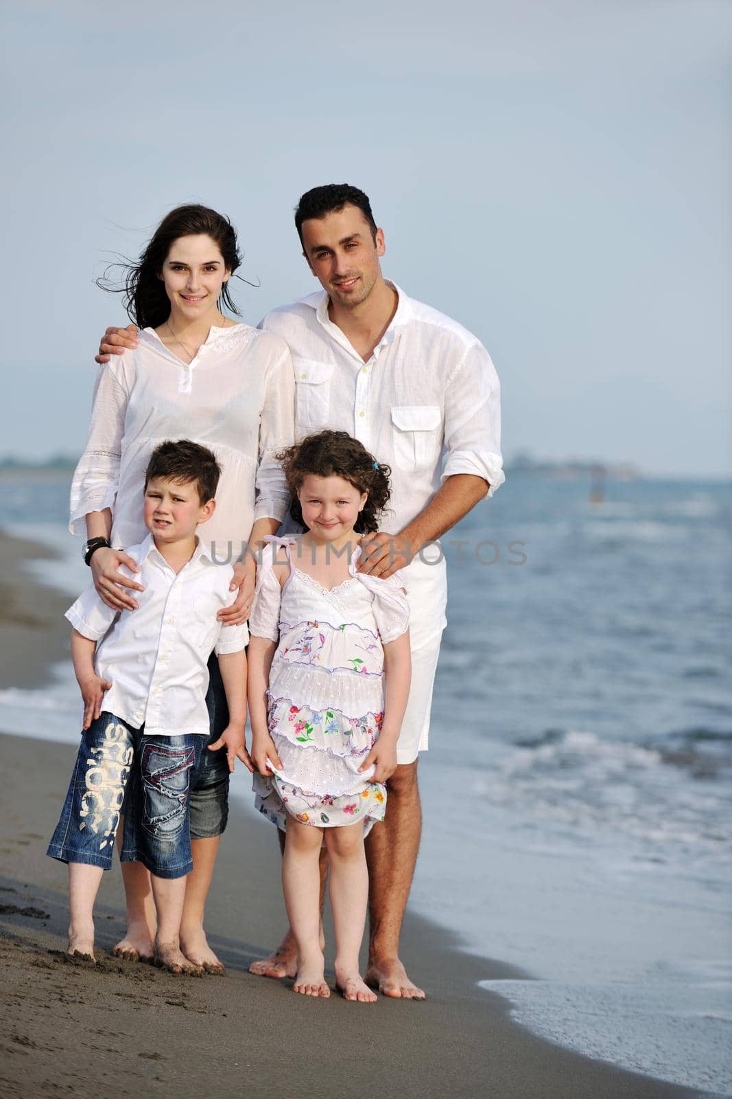 happy young family have fun and live healthy lifestyle on beach