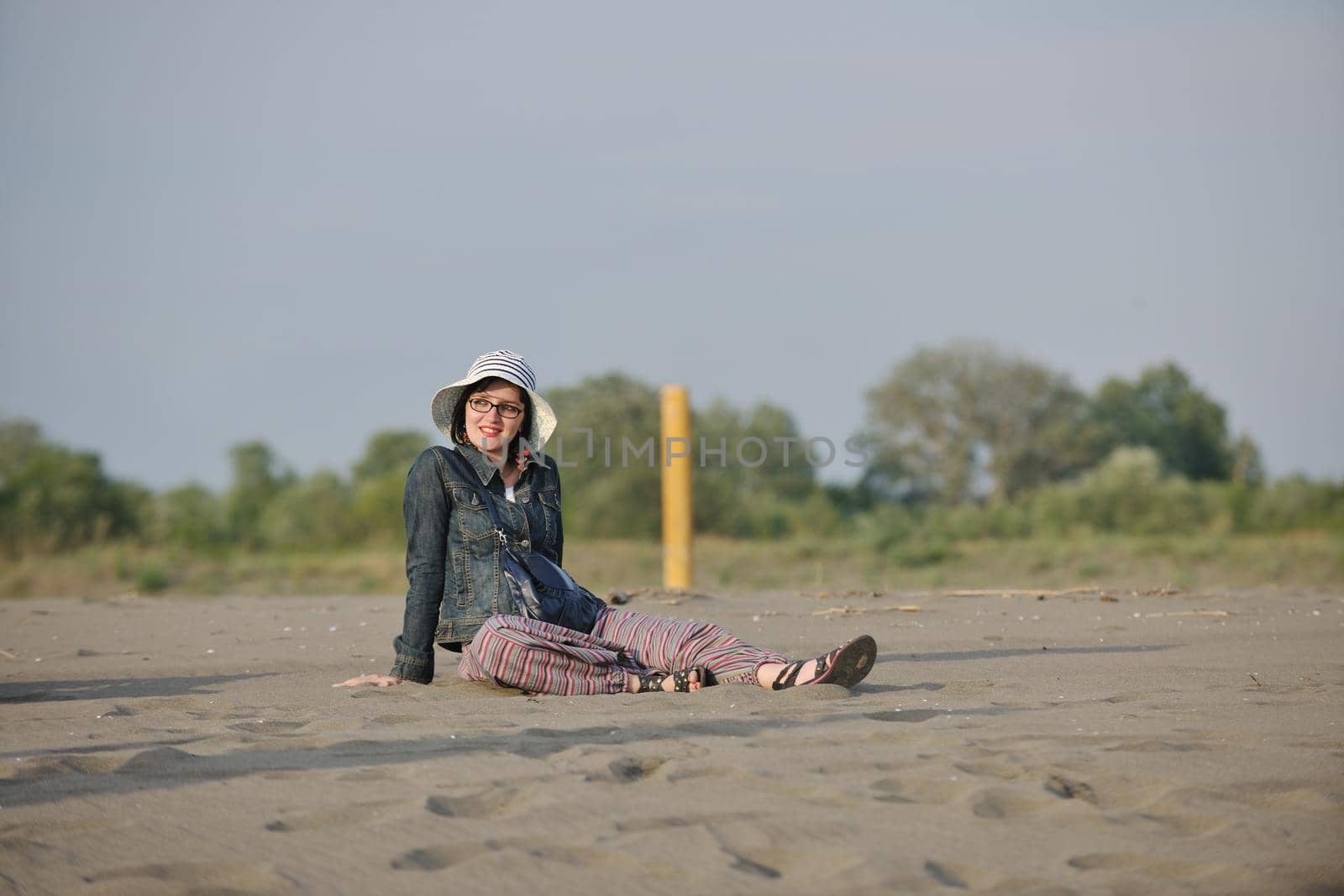 happy young woman on beach by dotshock