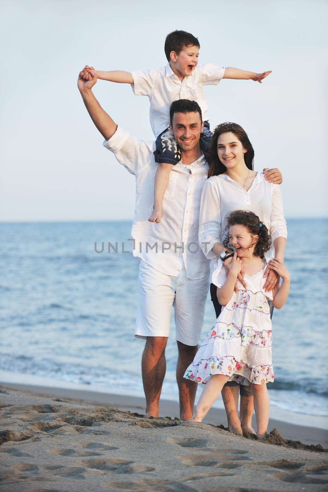 happy young family have fun and live healthy lifestyle on beach