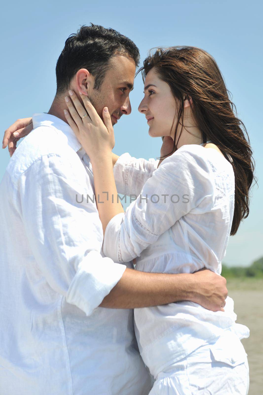 happy young couple have fun on beach by dotshock