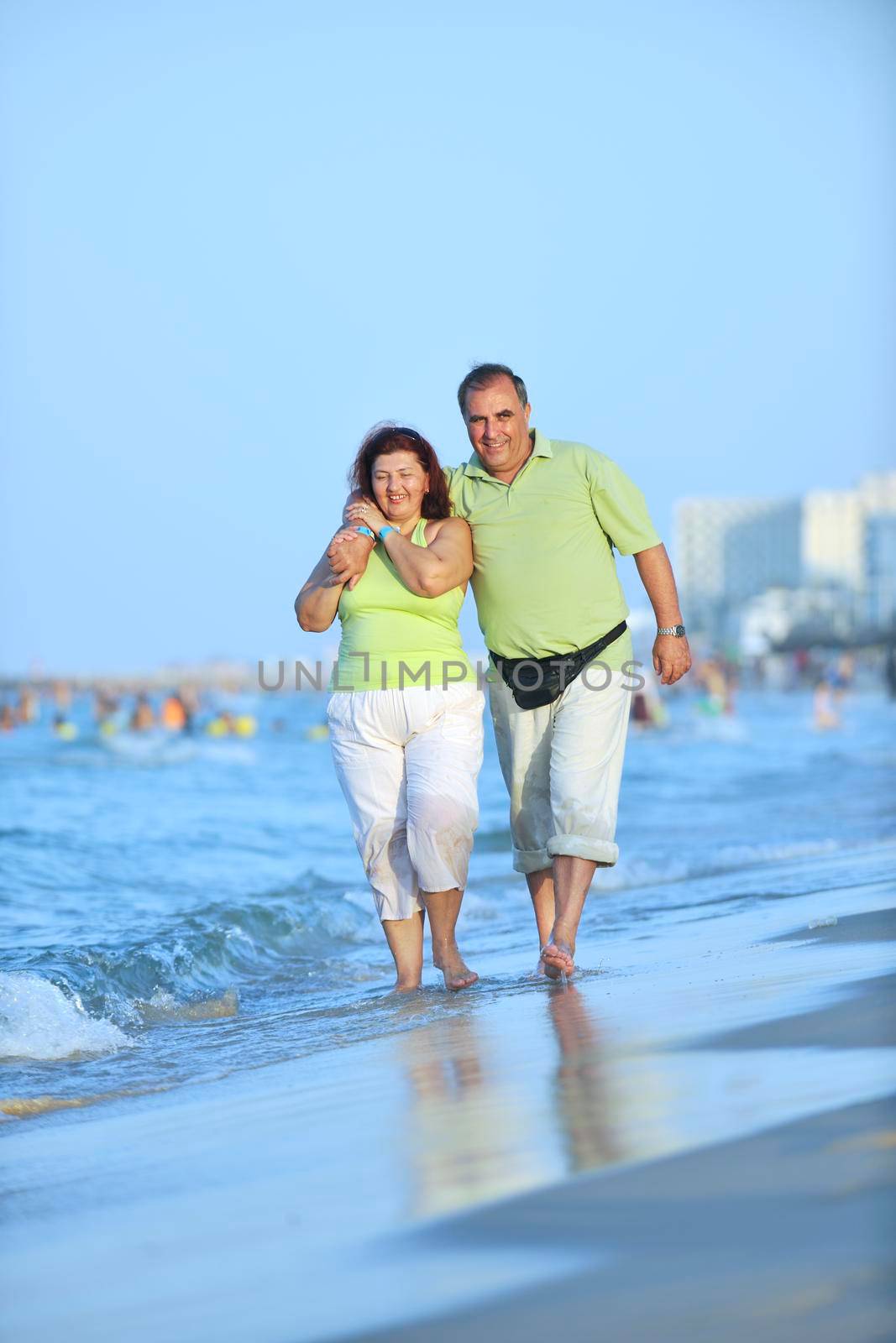 happy seniors couple  on beach by dotshock