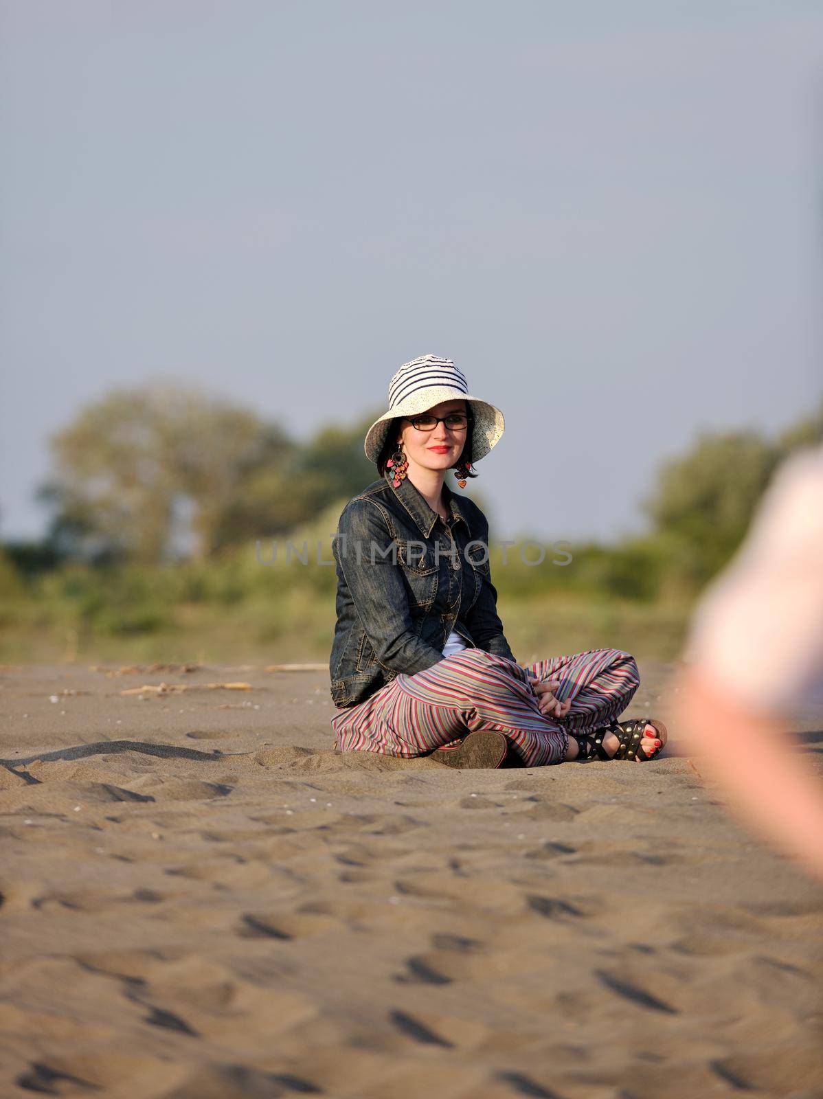 happy young woman relax on beautiful  beach at fresh summer morning and enjoy first ray of sun