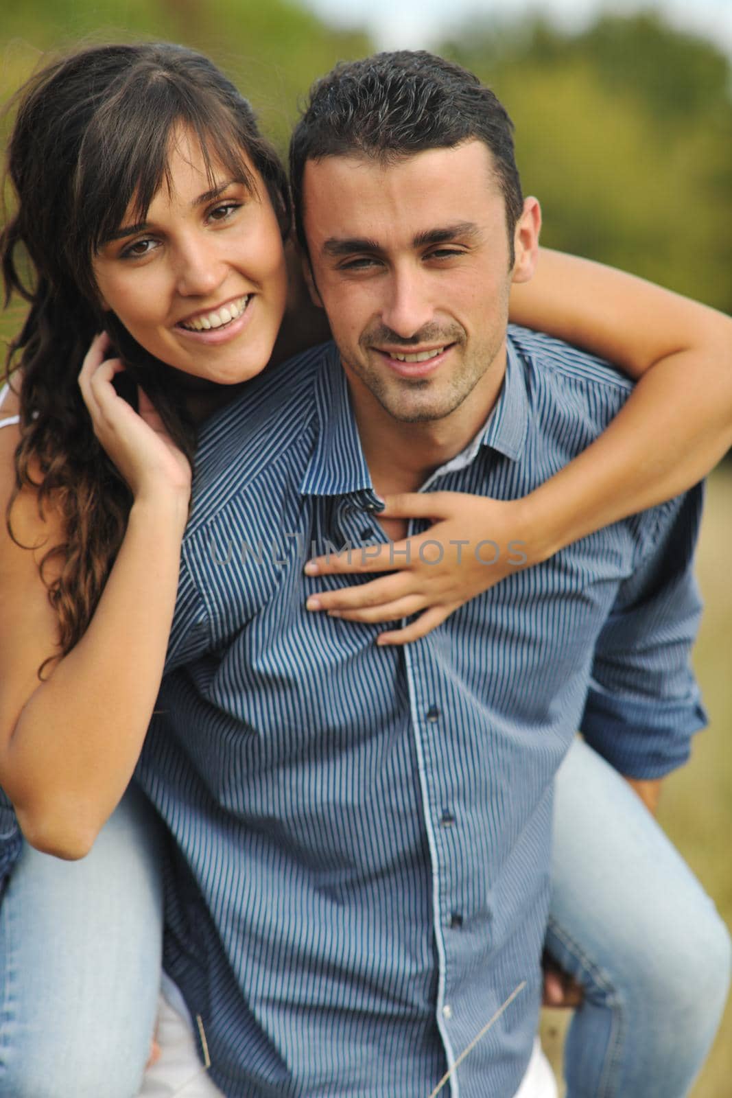 happy young couple have romantic time outdoor while smiling and hug