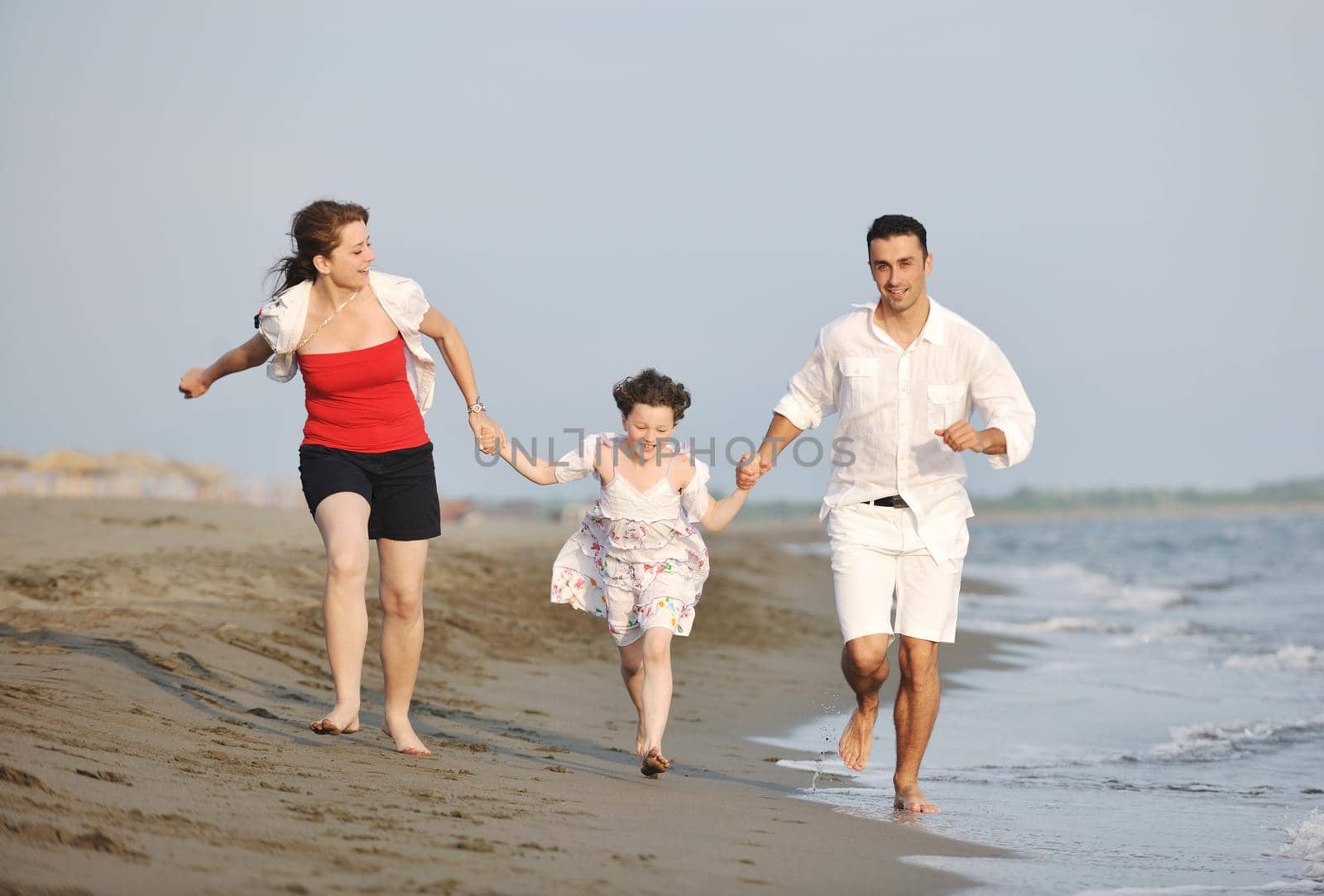 happy young family have fun and live healthy lifestyle on beach