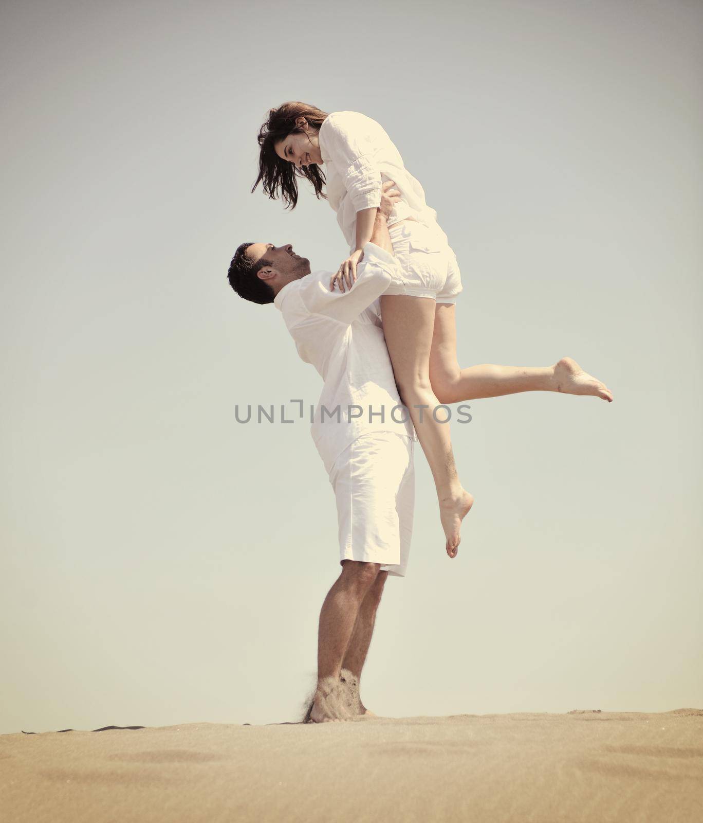 happy young couple have fun and romantic moments on beach at summer season and representing happynes and travel concept