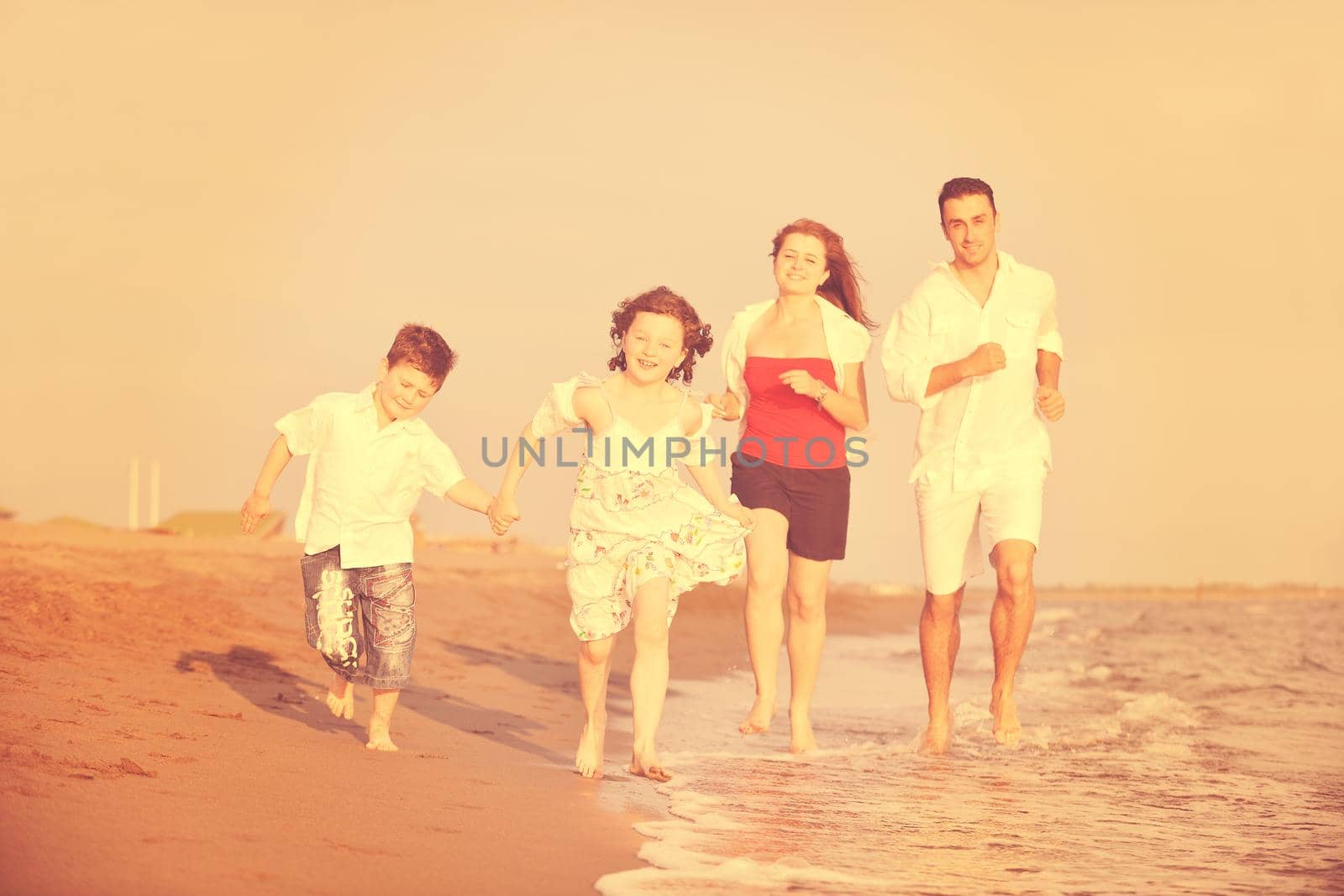 happy young family have fun on beach by dotshock