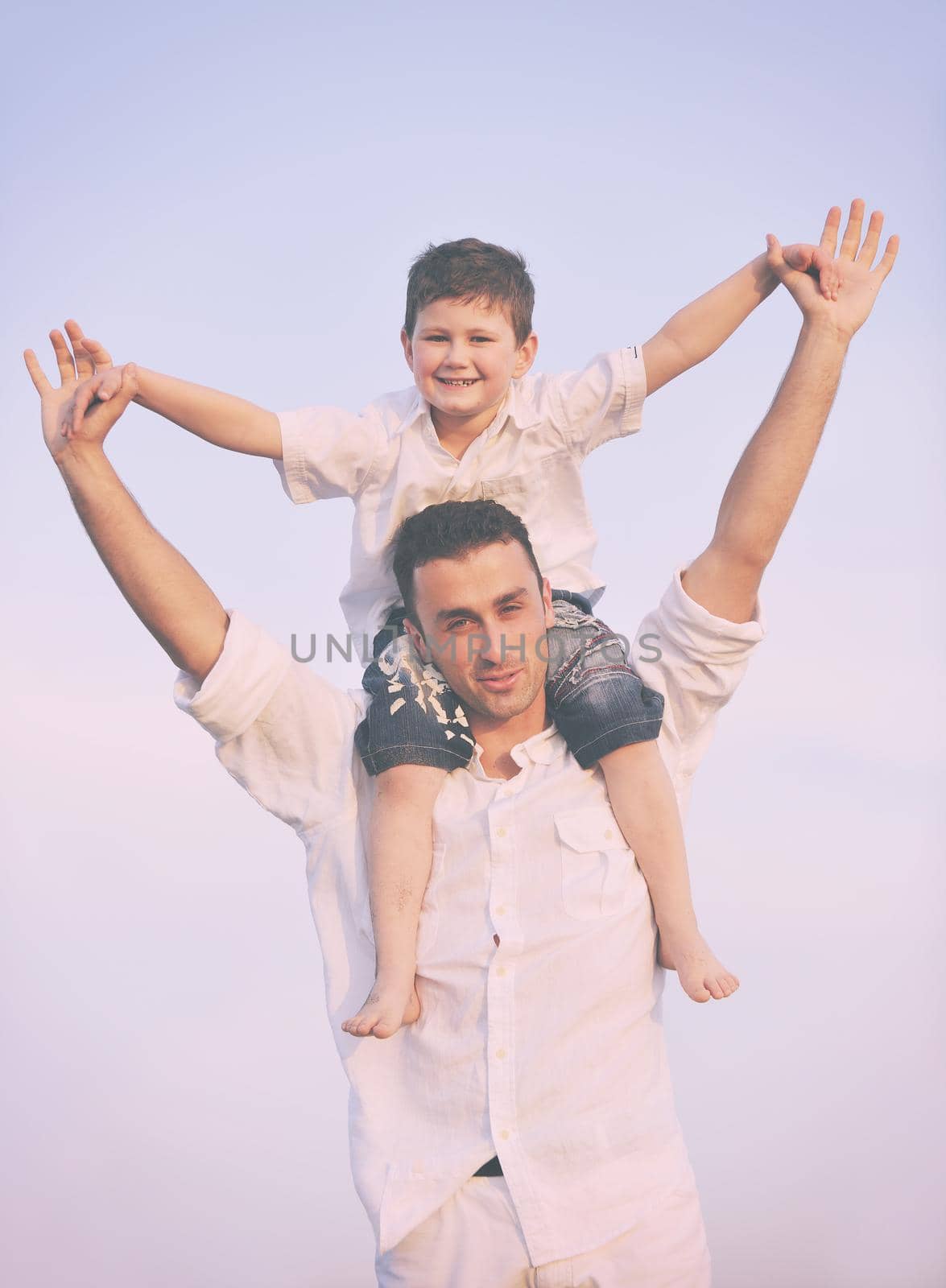 happy young family have fun on beach by dotshock