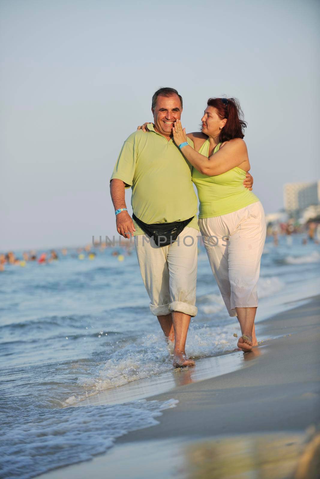 happy seniors couple  on beach by dotshock