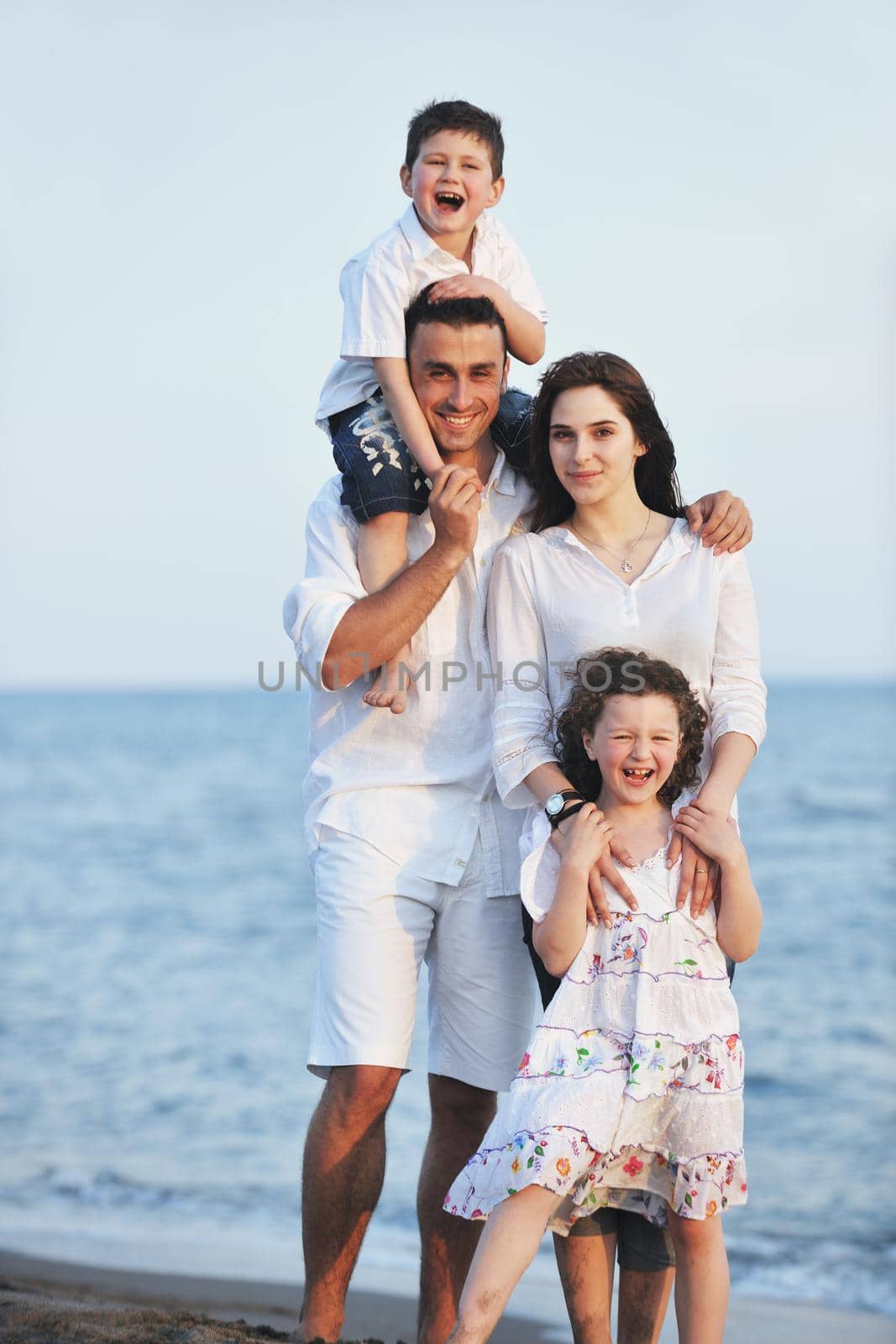 happy young family have fun on beach by dotshock