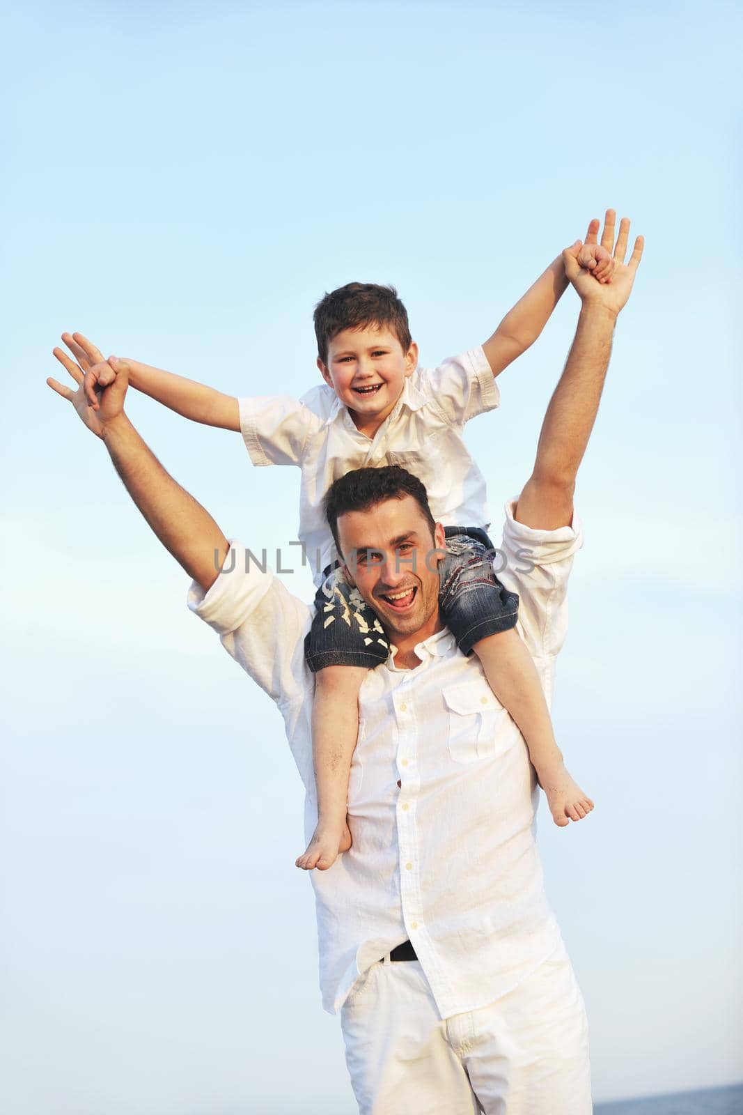 happy young family have fun and live healthy lifestyle on beach