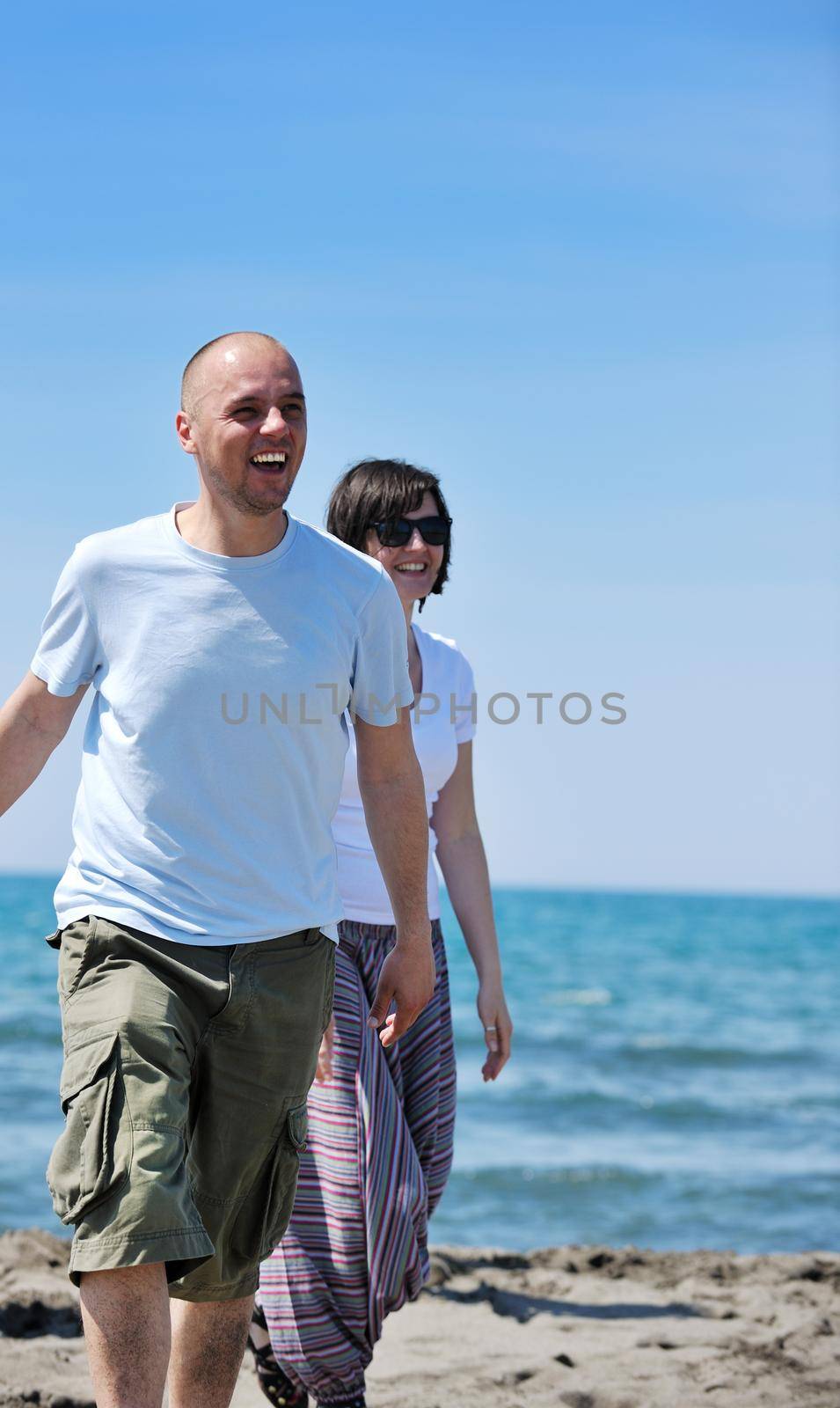 happy young couple have fun and romantic moments on beach at summer season and representing happynes and travel concept