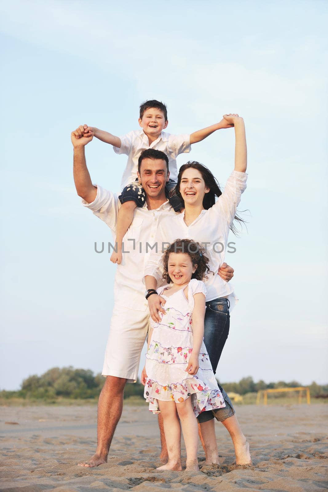 happy young family have fun and live healthy lifestyle on beach